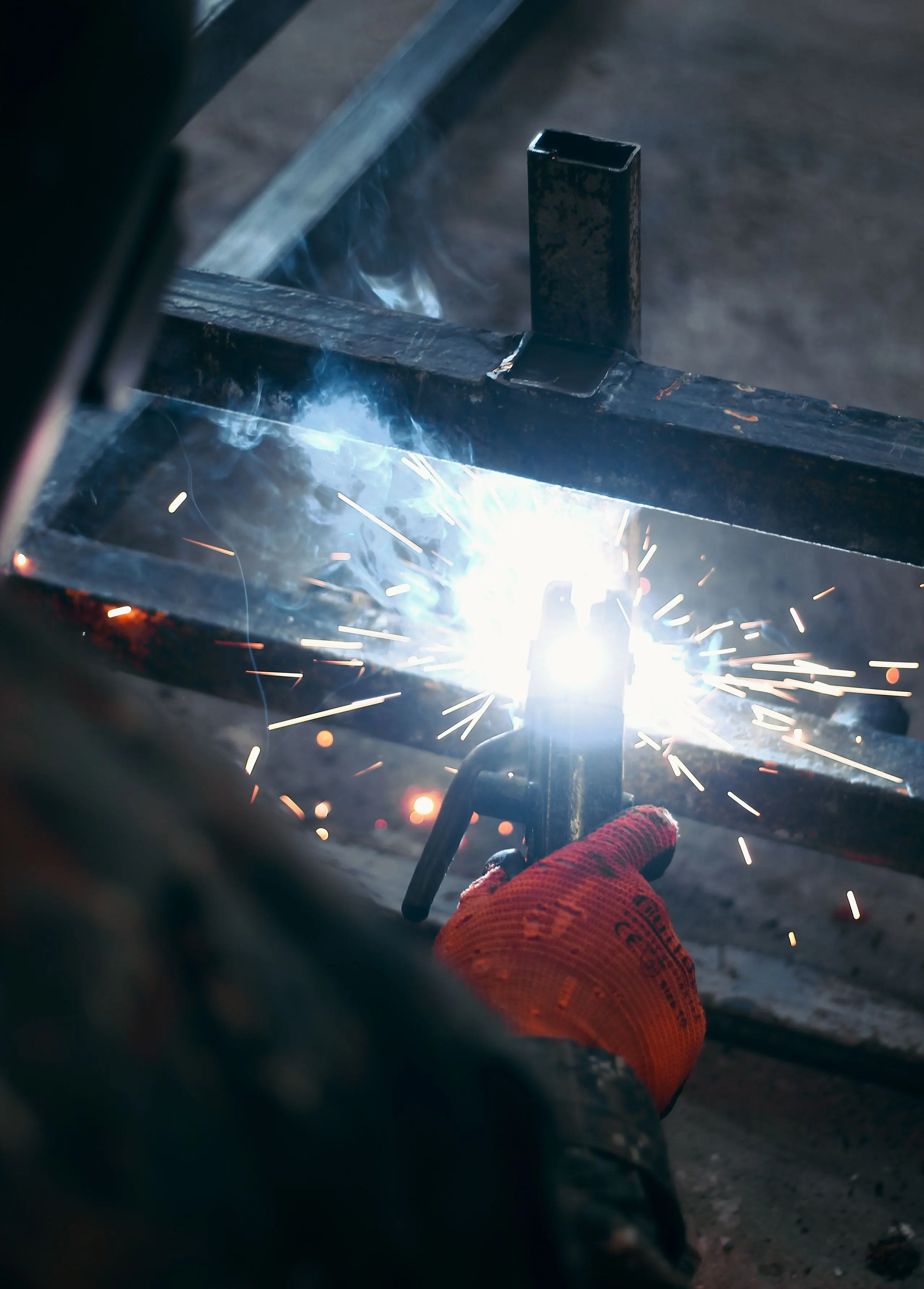 Welder working with flying sparks